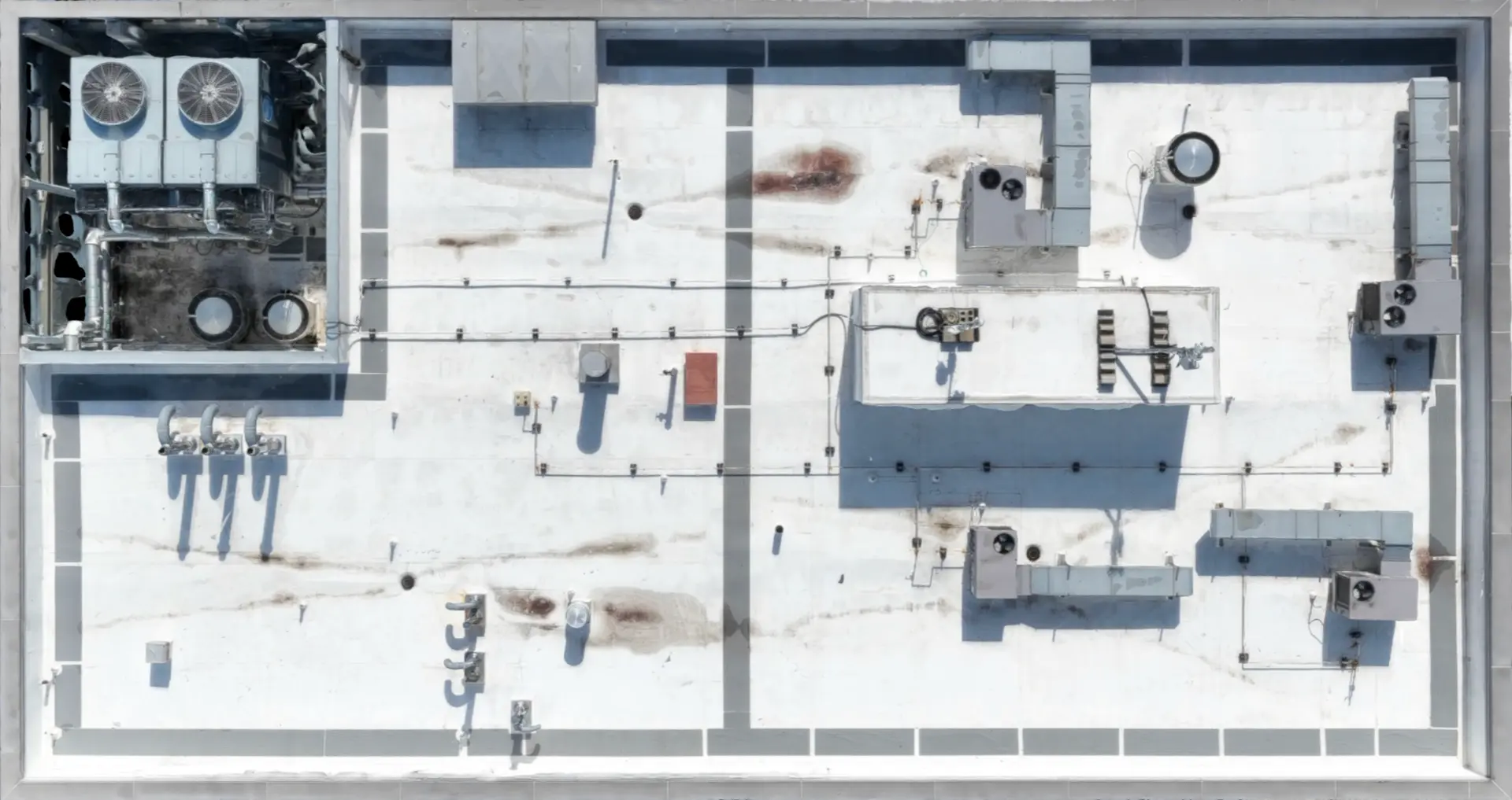 High-resolution overhead detail of a commercial building roof and installed equipment
